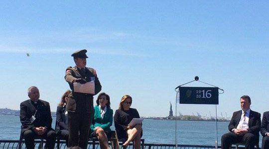 Captain Peter Kelleher reads the Proclamation against the backdrop of the Statue of Liberty & Ellis Island