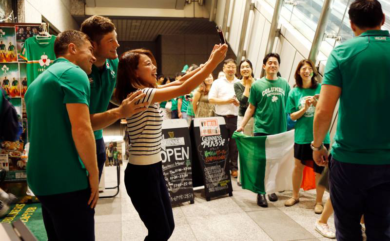 Rugby fan takes a selfie with Irish players at Dubliners' Pub in Tokyo. Photo Credit: Shigeru Matsuzaki