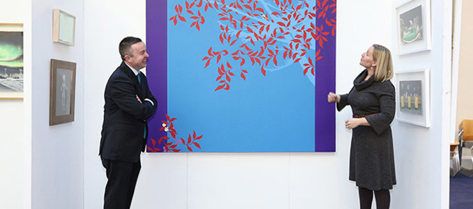 Minister Hayes and Minister Creighton viewing some of the art work before the exhibition began its tour.
