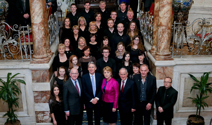 Pic shows from left Minister for Foreign Affairs and Trade, Charlie Flanagan, TD , British Foreign Secretary, Rt Hon Philip Hammond MP , former President, Professor Mary McAleese and her husband Dr Martin Mc Aleese with the Island of Ireland peace choir, at the fifth Iveagh House Commemorative lecture .  Pic Maxwell's - No Repro Fee   16-12-14