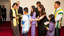 Visit of Aung San Suu kyi to Ireland. The Tanaiste and Minister for Foreign Affairs and Trade, Eamon Gilmore, TD greets Aung San Suu Kyi this afternoon at Dublin Airport and is presented with flowers from Saw Pu, aged 11, Sophia Kelly, aged 12.
