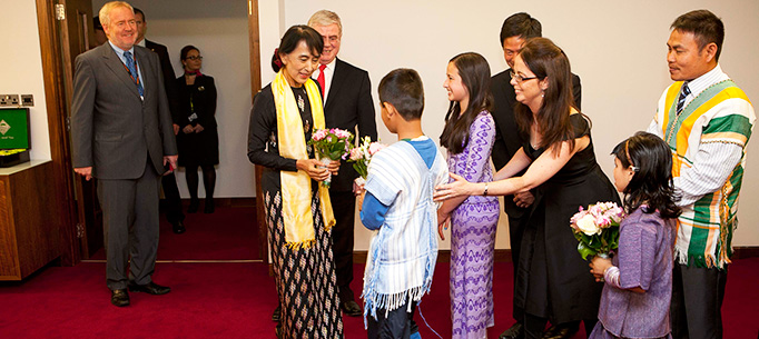Visit of Aung San Suu kyi to Ireland. The Tanaiste and Minister for Foreign Affairs and Trade, Eamon Gilmore, TD greets Aung San Suu Kyi this afternoon at Dublin Airport and is presented with flowers from Saw Pu, aged 11, Sophia Kelly, aged 12.
