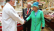 Her Majesty Queen Elizabeth II  meeting trader Jerry Moynihan on a tour of  The Old English Market, Cork City, on her on Friday on her State Visit to Ireland.
