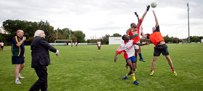 President Michael D Higgins throws the ball in to start the SA Gaels Blitz, final match with Keith O'Leary from ESB International who sponsor the SA Gaels and will be sponsoring their second tour to Ireland in 2015,  during a visit to the High Performance Centre at the University of Pretoria in South Africa.Photo Chris Bellew / Copyright Fennell Photography 2014