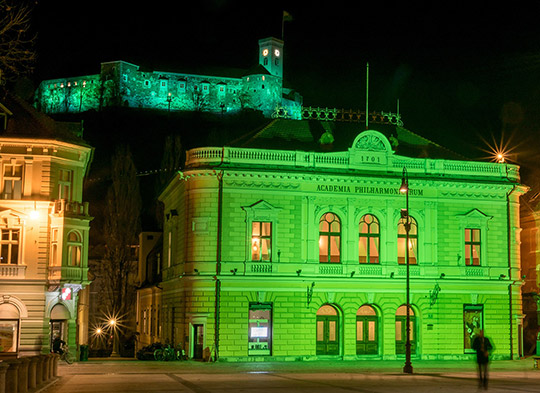 Ljubljana Castle and the Slovenian Philharmonic Hall gone green for St. Patrick's Day - Author: Picasa
