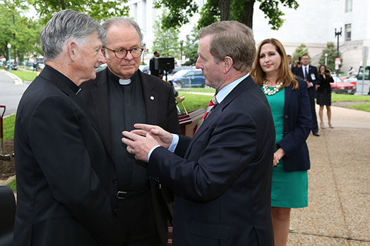 Taoiseach speaking with Fr. Conroy and Fr. McBride