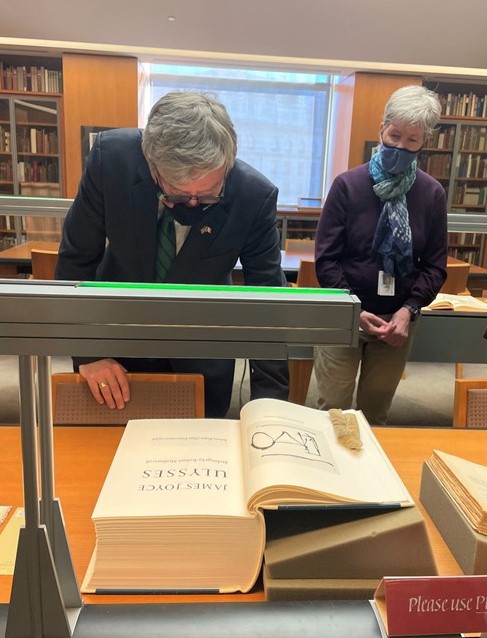 Ambassador Mulhall looking at a copy of Ulysses with illustrations by Robert Motherwell at SF Public Library
