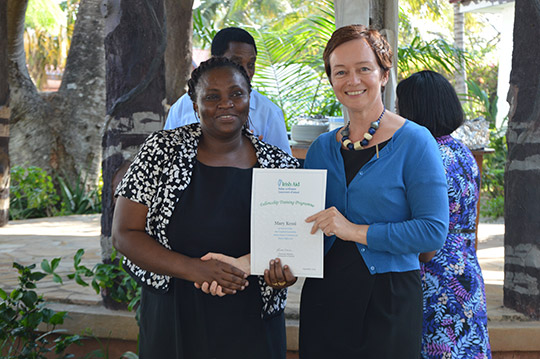 Ambassador Gilsenan presents a Certificate of Achievement to Mary Kessi, an alumni of National University of Ireladn Galway.